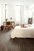 Modern bedroom with a bed, desk, and window