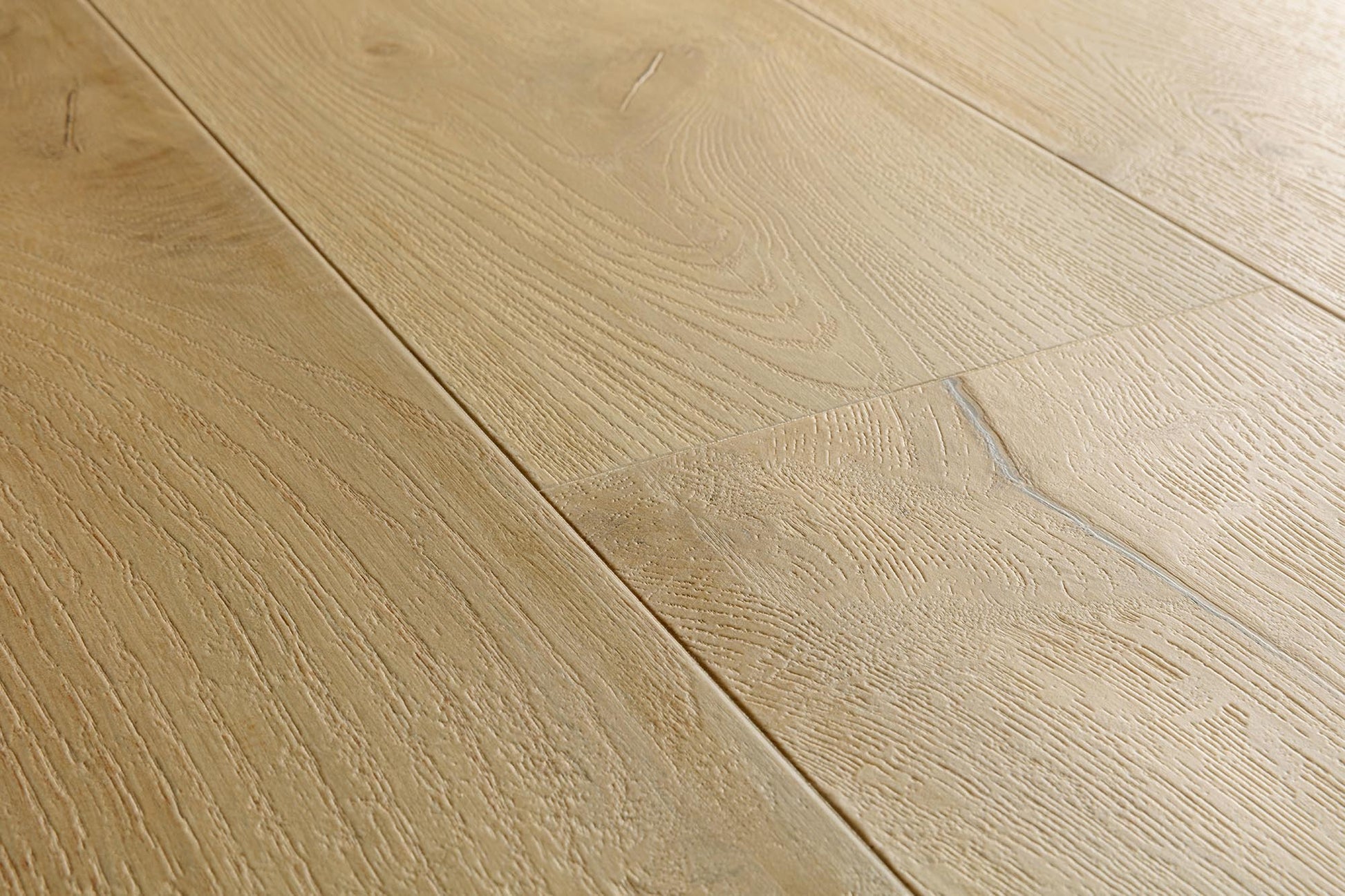 Light oak wood flooring planks with visible natural grain patterns and subtle seams.