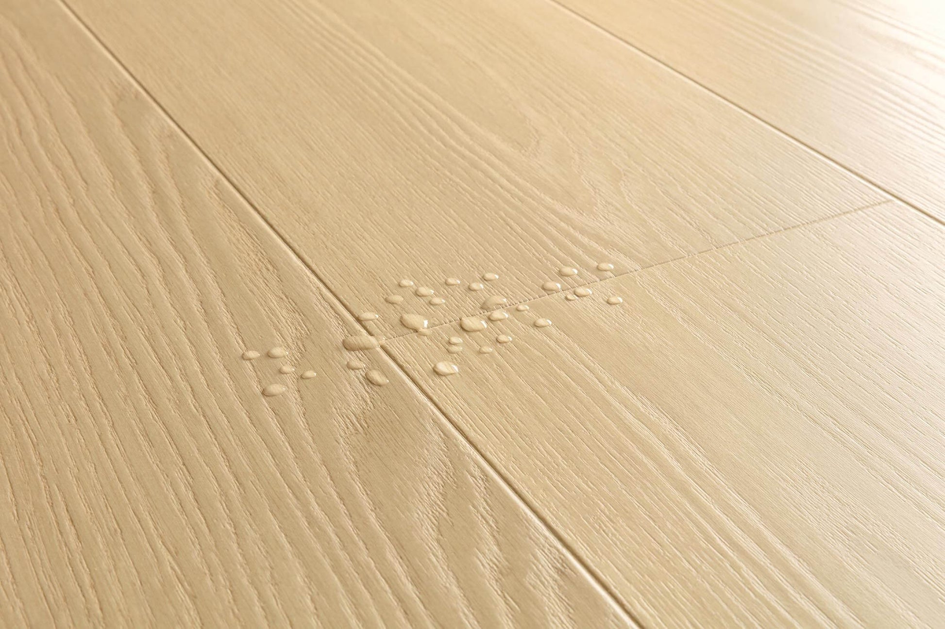 Light beige wood-look floor planks with visible grain texture and a small cluster of water droplets in the center.