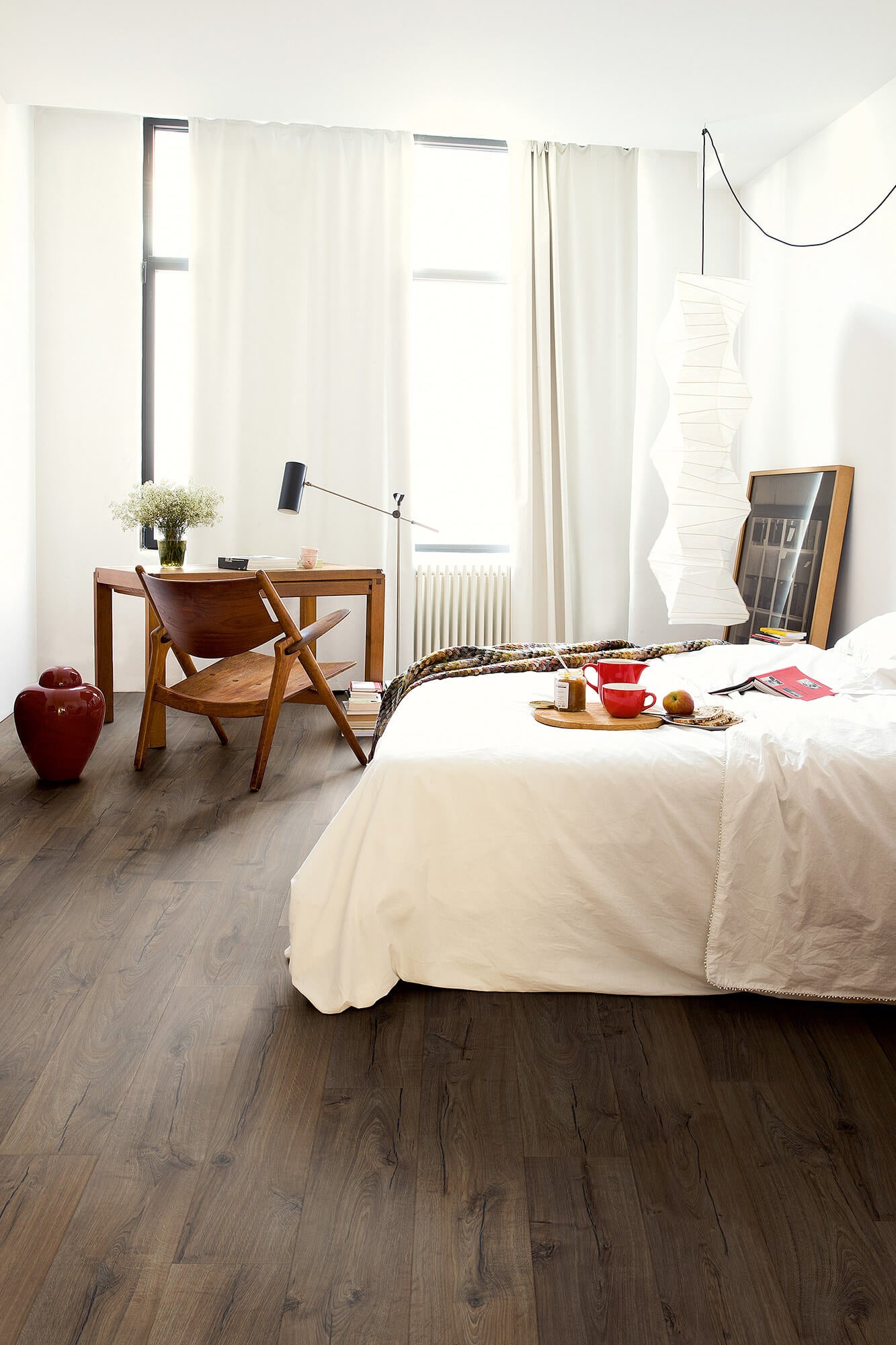 Modern bedroom with a bed, desk, and chair.