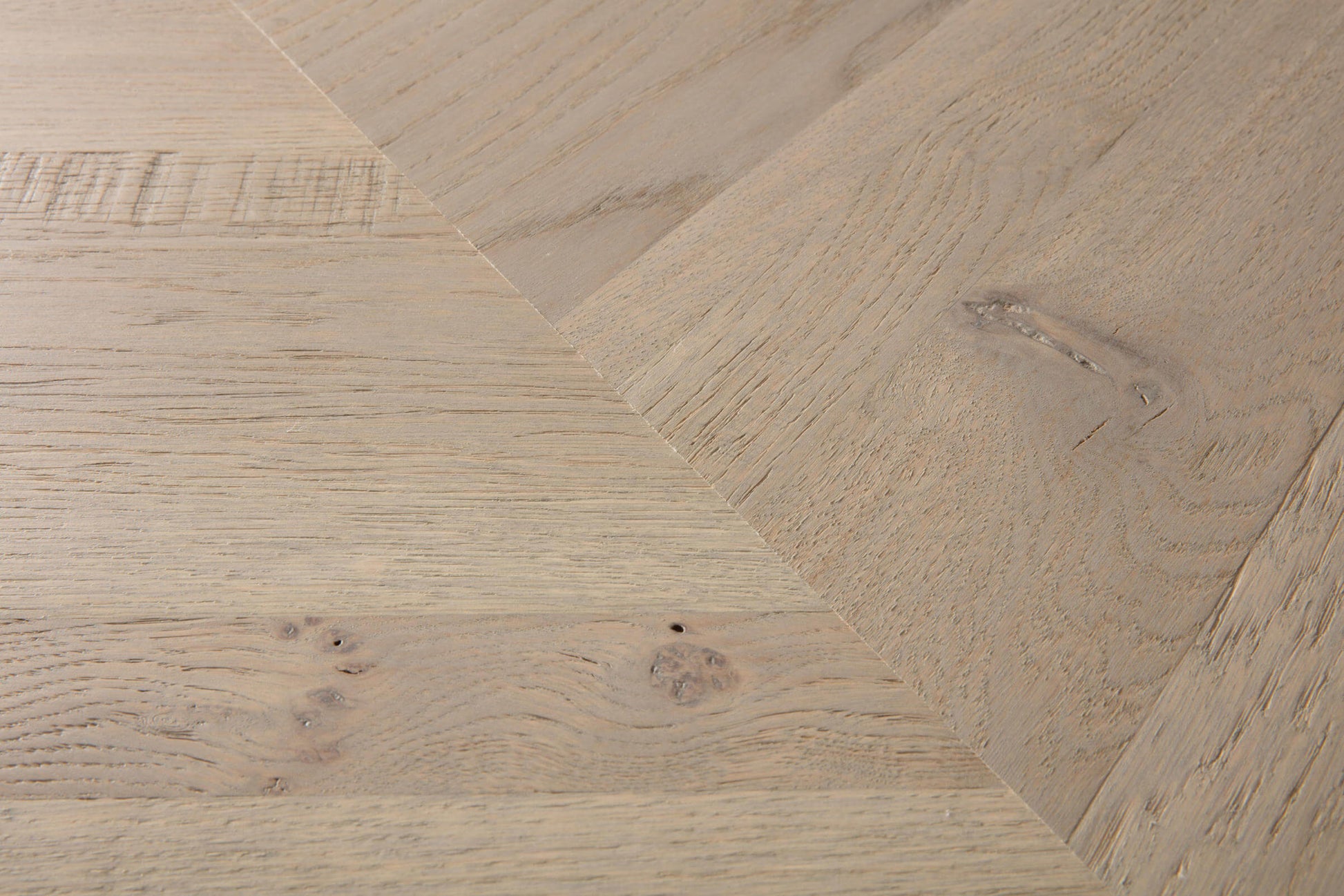 Close-up of wooden flooring with a herringbone pattern