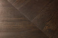 Close-up of dark wood flooring with a chevron pattern
