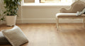 Living room with wooden floor, white cushion, and decorative bench.