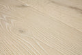 Close-up of a beige wooden surface with visible grain patterns