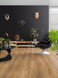 Modern living room with wooden flooring, black wall, and decorative items.