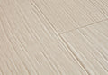 Close-up of a tiled floor with beige tiles