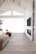Modern living room with a TV mounted on a wall, a fireplace, and a couch.