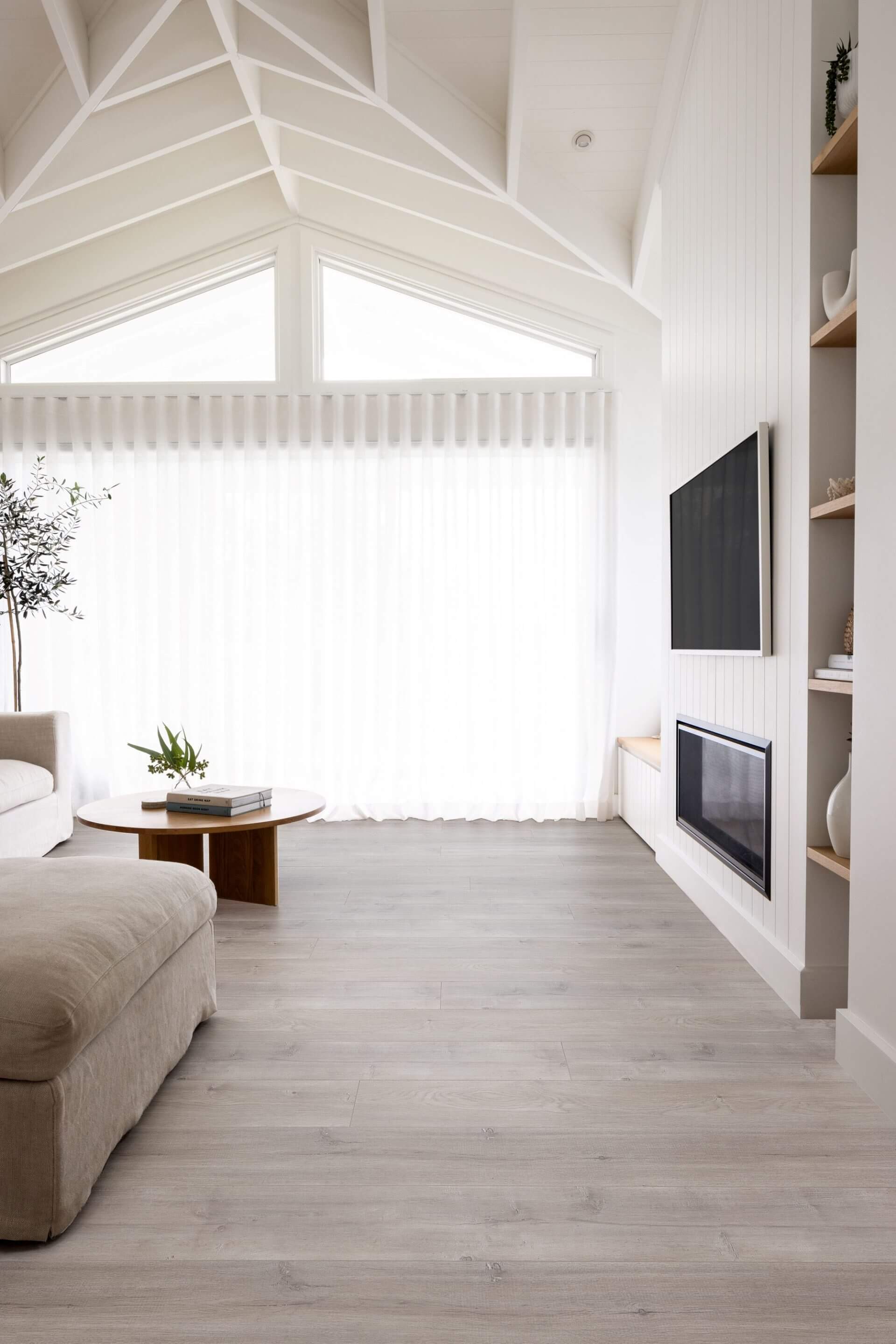 Modern living room with a TV mounted on a wall, a fireplace, and a couch.