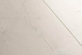 Close-up of a light gray ceramic tile with subtle texture