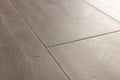 Close-up of gray wooden flooring with a focus on texture and pattern.