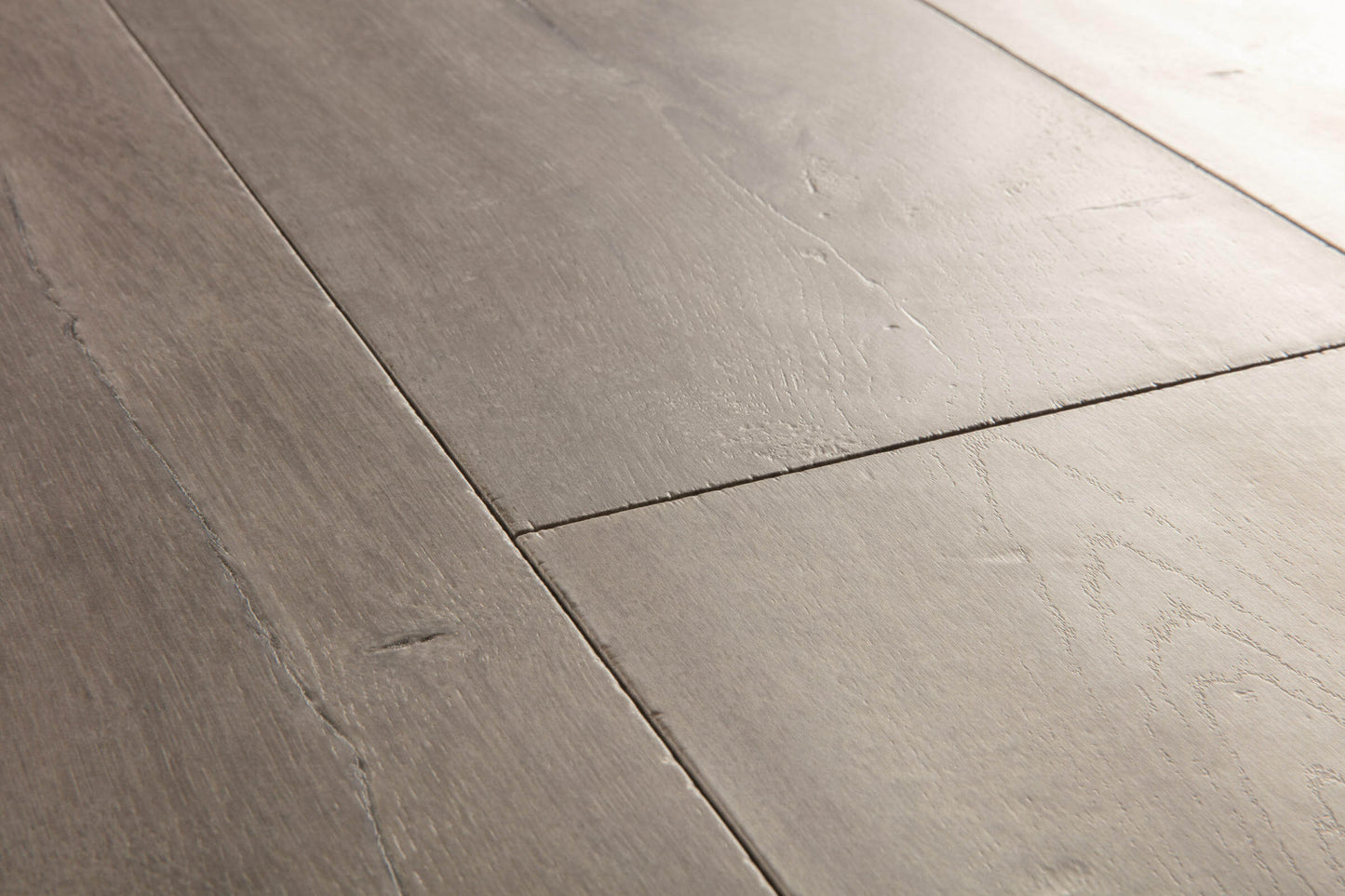 Close-up of gray wooden flooring with a focus on texture and pattern.