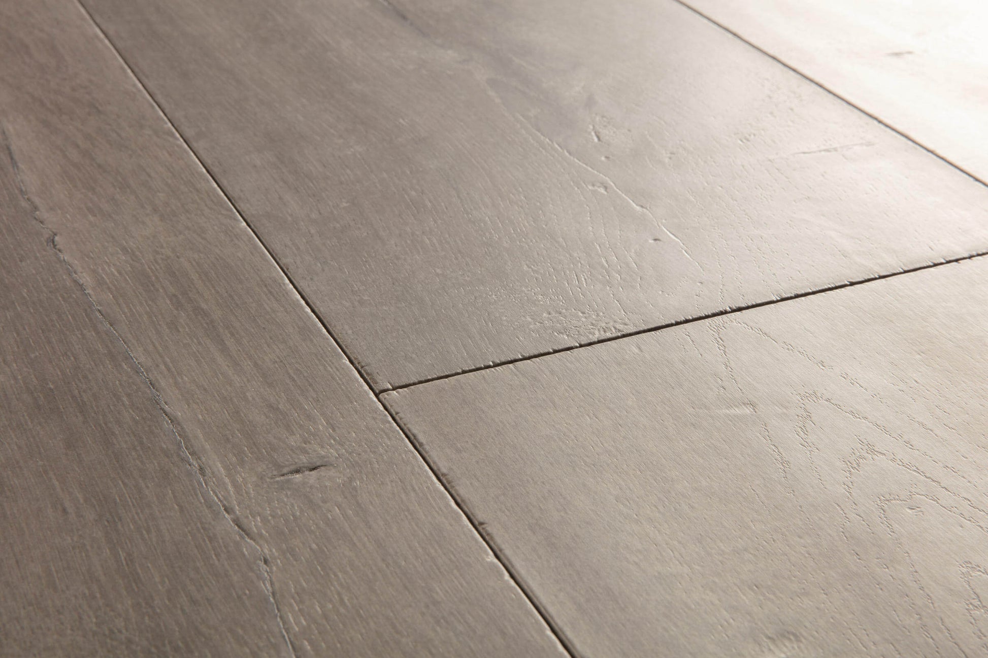Close-up of gray wooden flooring with a focus on texture and pattern.