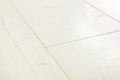 Close-up of white wooden flooring with a herringbone pattern