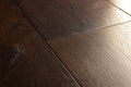 Close-up of dark wooden flooring with visible grain and texture.