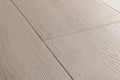 Close-up of gray wooden flooring with a visible grain pattern.