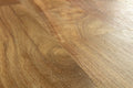 Close-up of a wooden floor with a warm brown color.