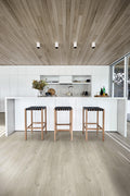 Modern kitchen with wooden stools and a white countertop