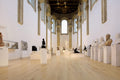 Museum gallery with classical sculptures on pedestals