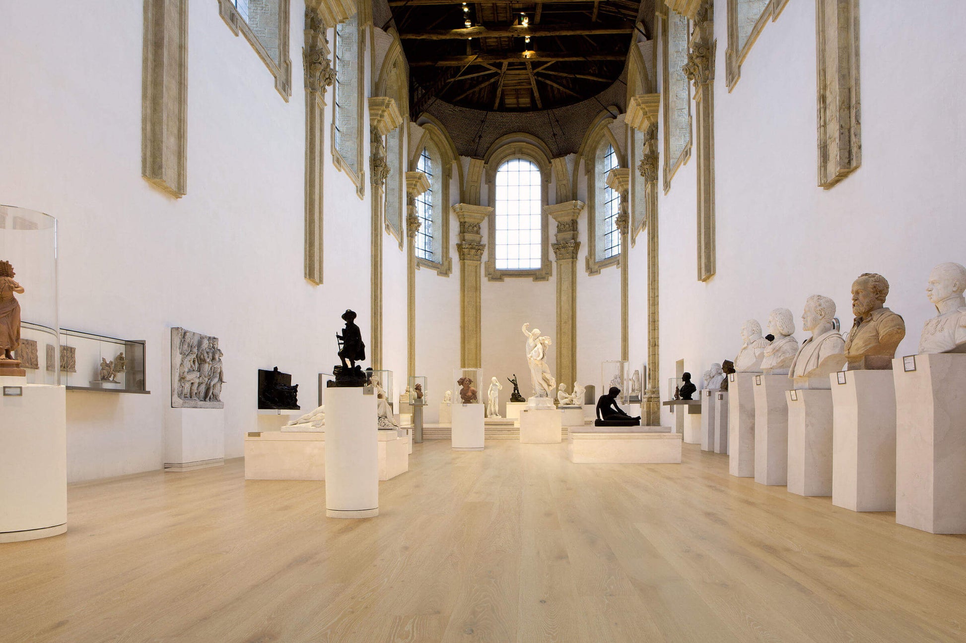 Museum gallery with classical sculptures on pedestals