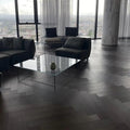 Modern living room with glass coffee table and city view
