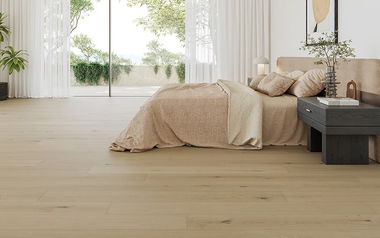 Modern bedroom with wooden flooring, bed, and side table.