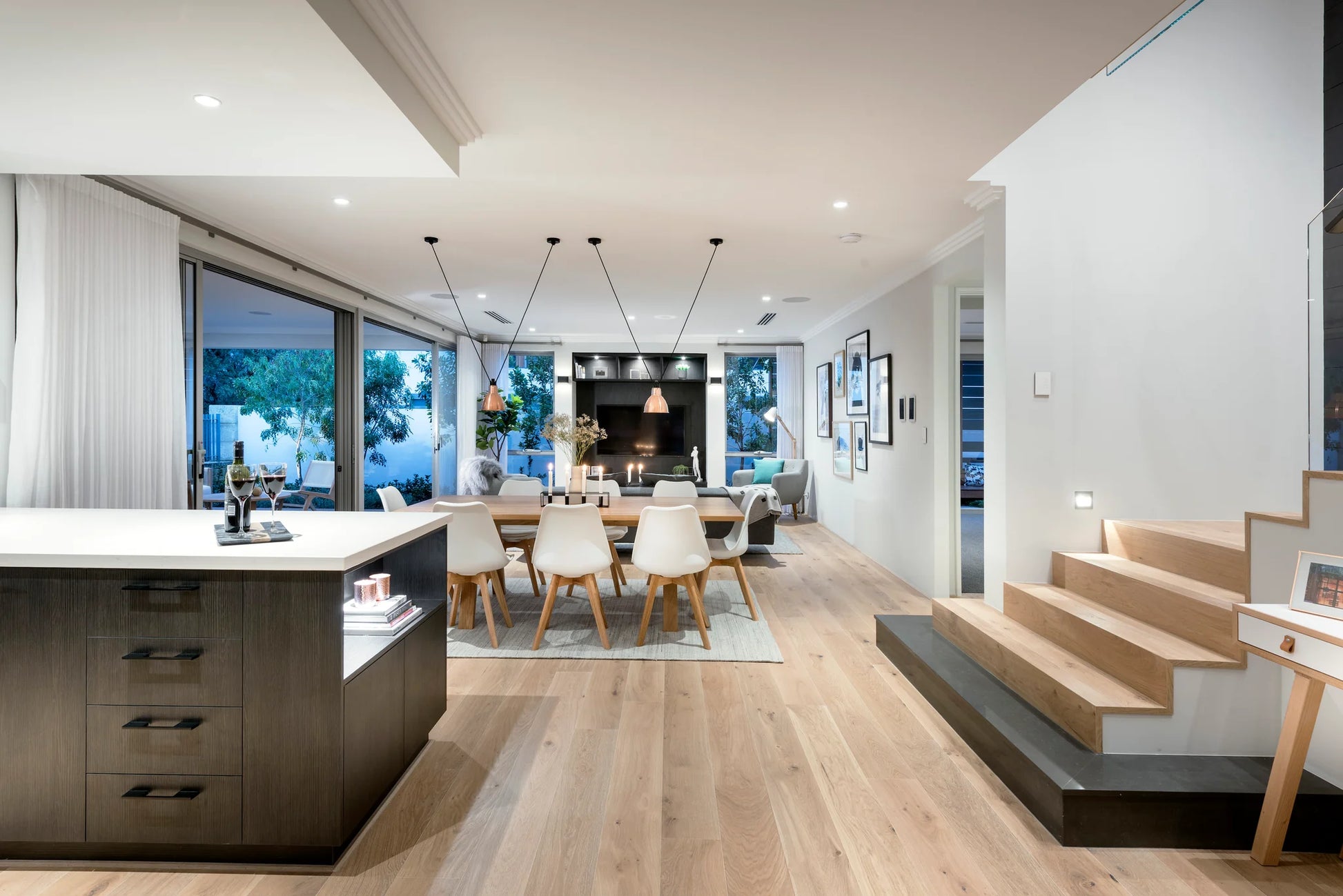 Modern open-plan living area with kitchen, dining, and living room.