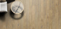 Wooden flooring with a round table and chair in a minimalistic setting