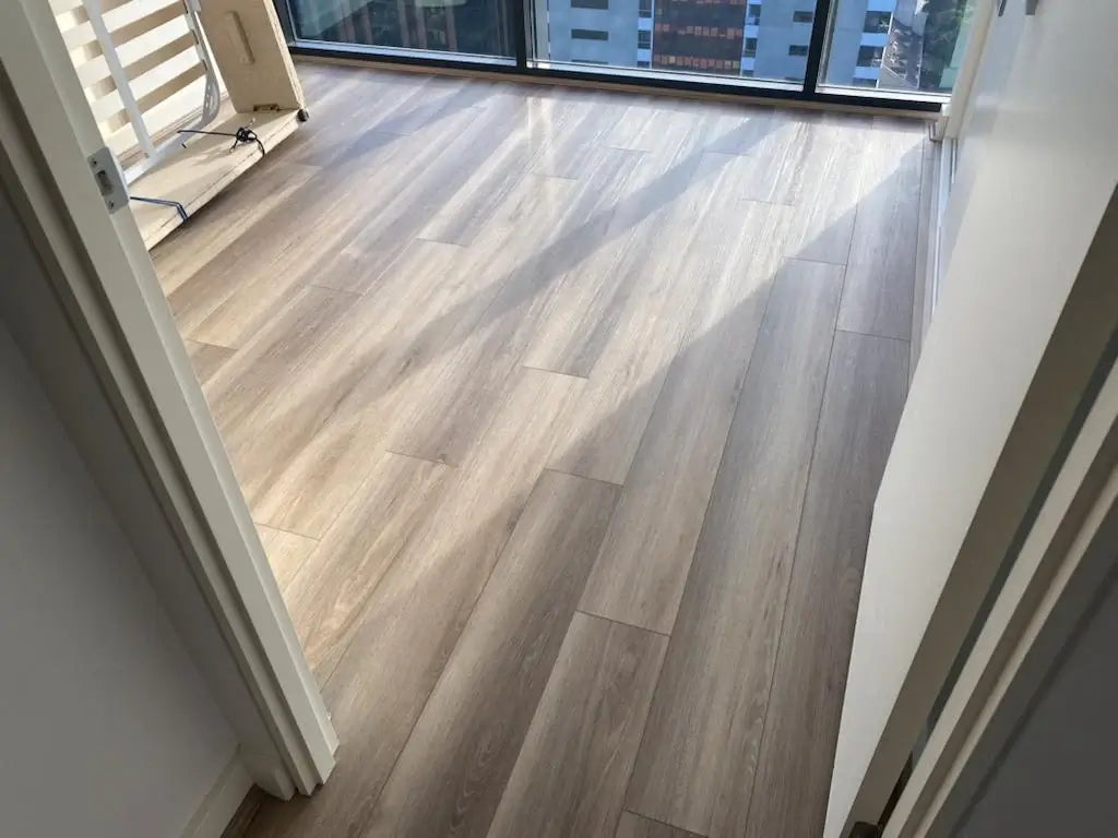 Wooden flooring in a room with large windows