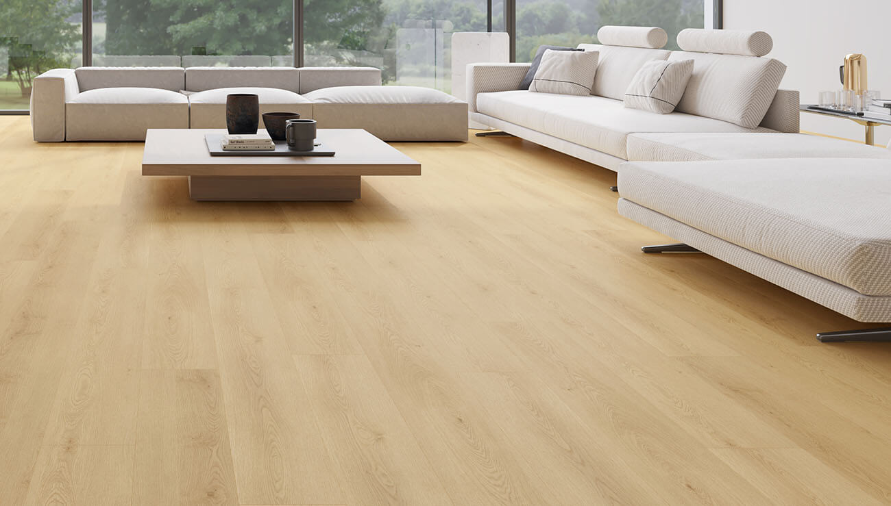 Modern living room with light wood flooring, white furniture, and decorative items.