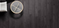 Round gray coaster with gold accents on a dark wooden surface