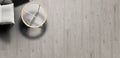 Round mirror with gold frame on a wooden floor