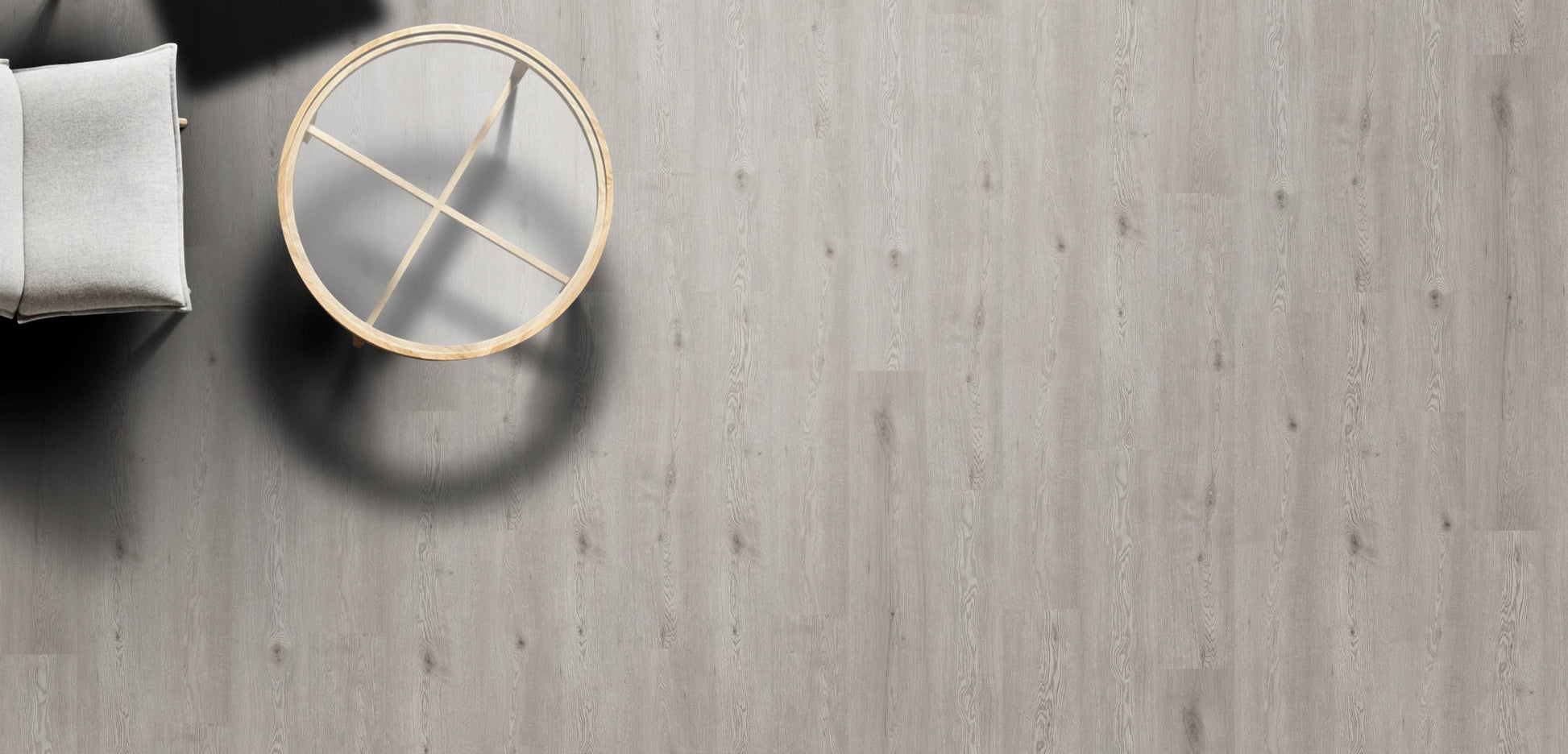 Round mirror with gold frame on a wooden floor