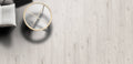 Round gold mirror on a light wooden floor with a neutral color palette