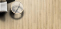 Wooden floor with a round mirror and a cushion on a light wooden surface