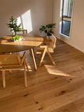 Dining area with wooden table and chairs on a wooden floor