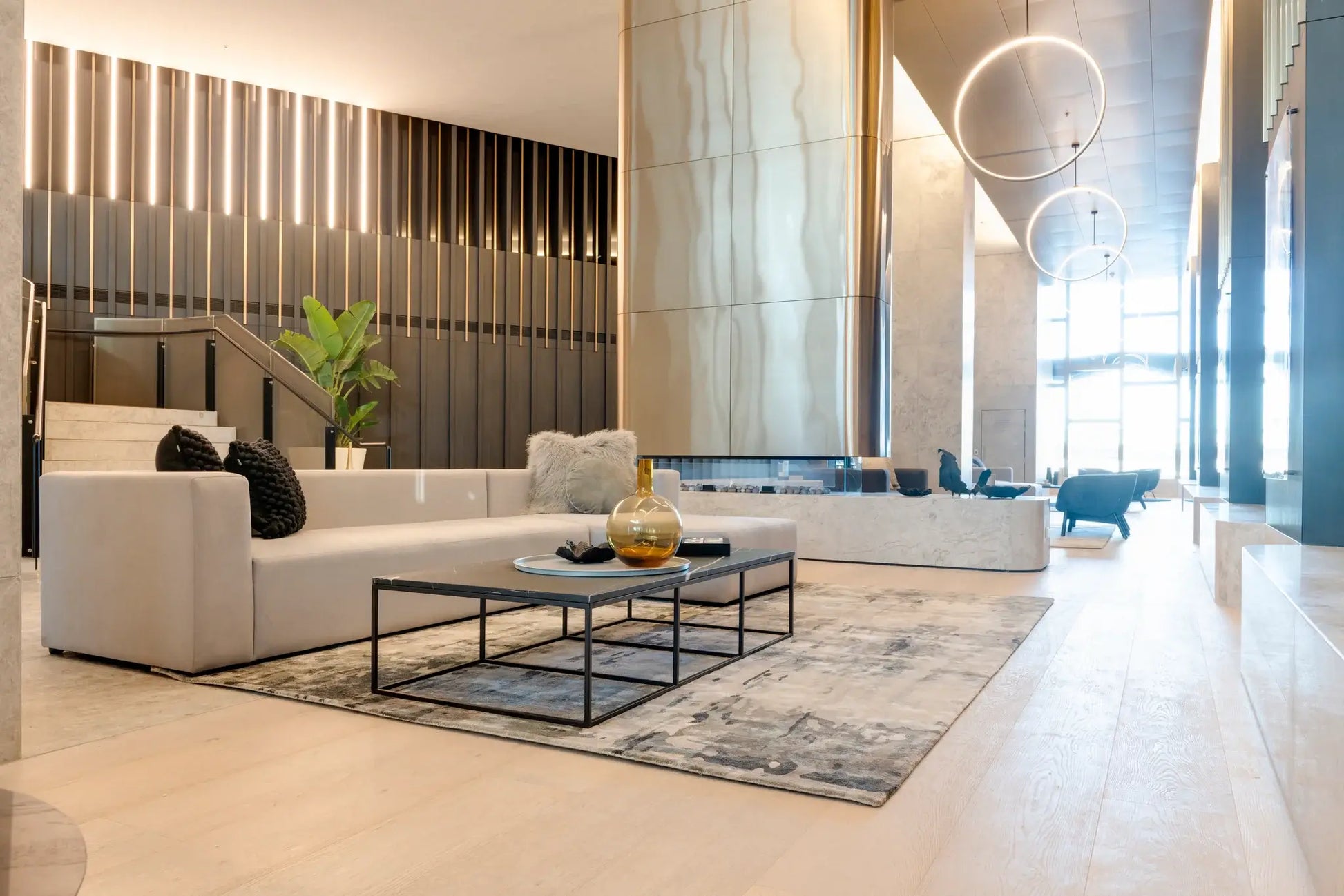 Modern living room with white sofa, coffee table, and decorative elements.