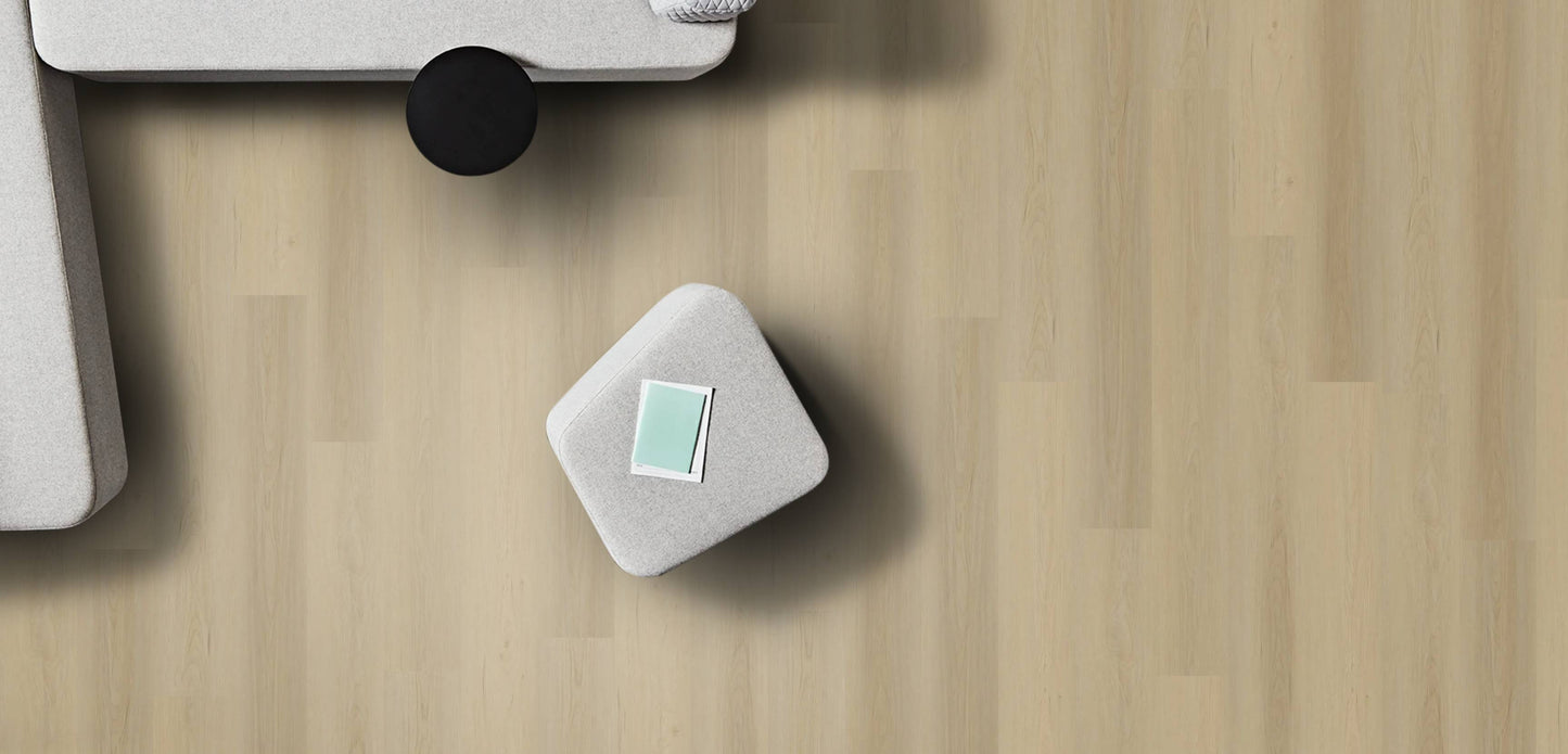 Small gray cube with a green label on a wooden surface