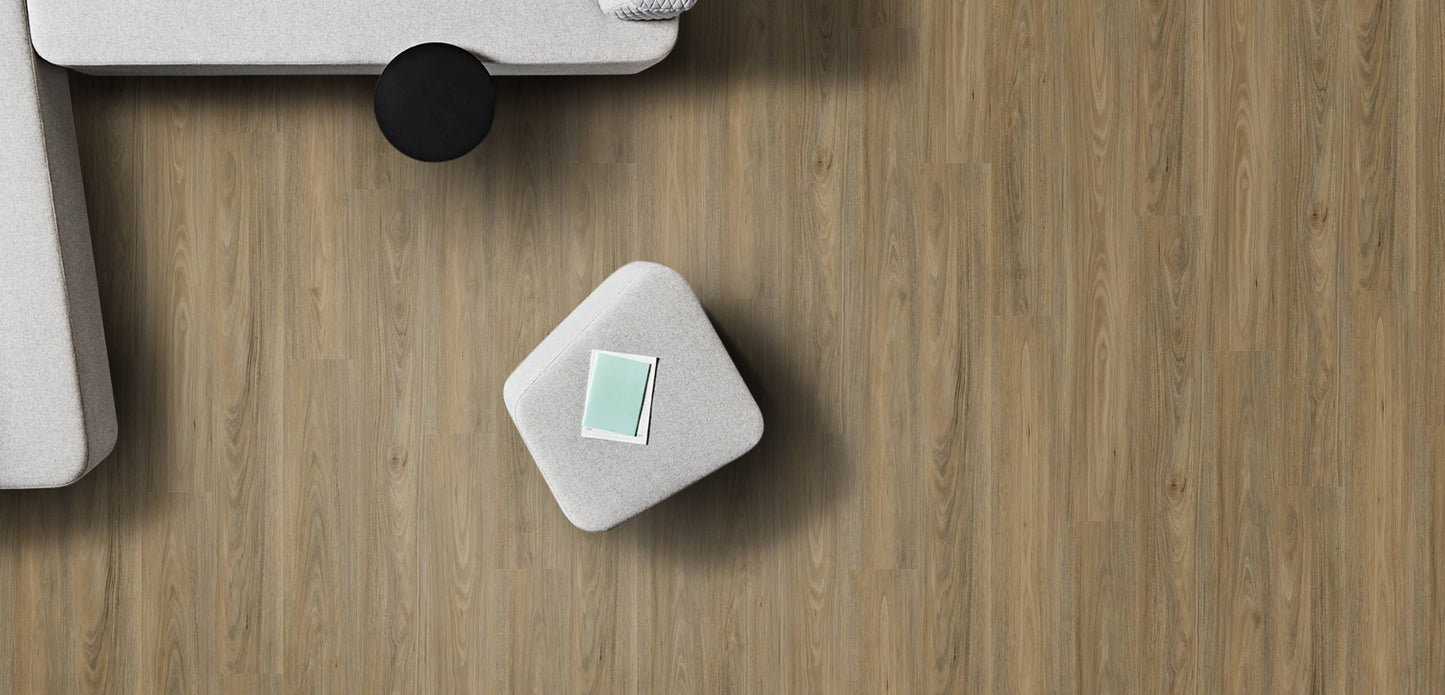 Small white square object with a green label on a wooden surface
