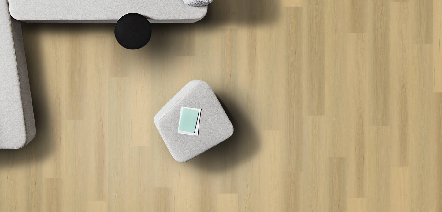 Small gray cube with a green label on a wooden surface