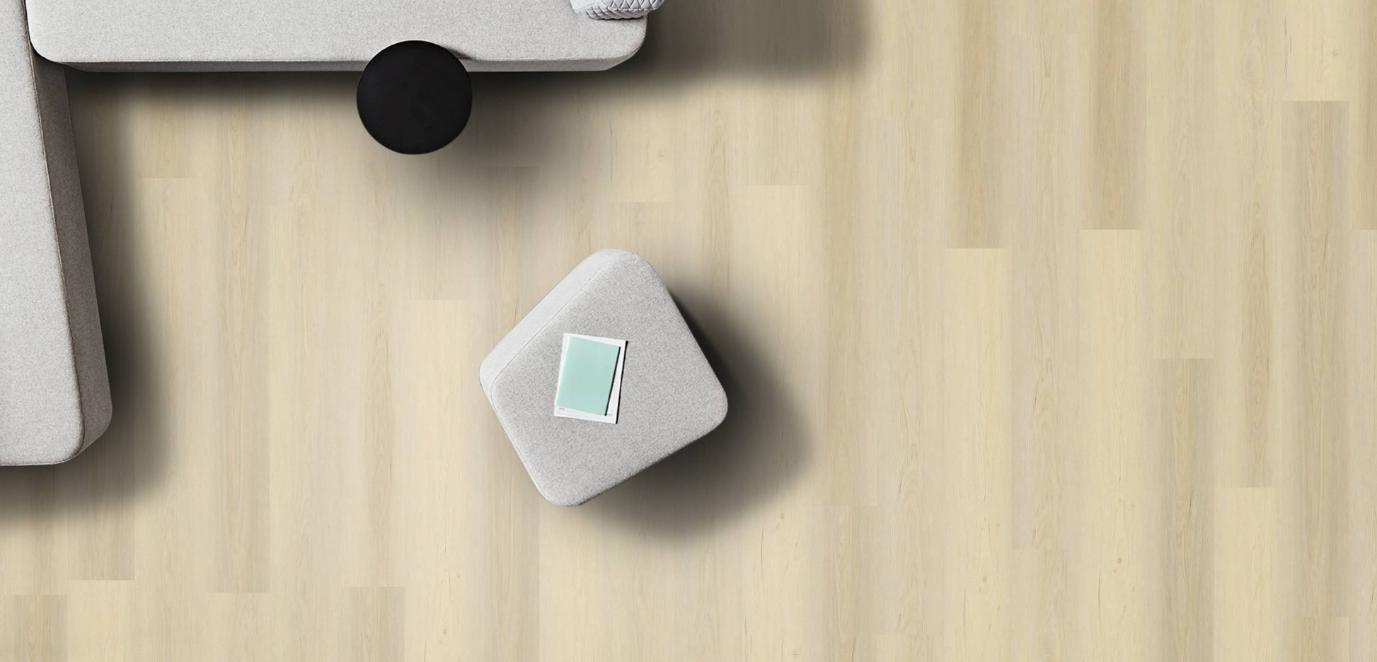 Small gray cube with a green label on a wooden surface