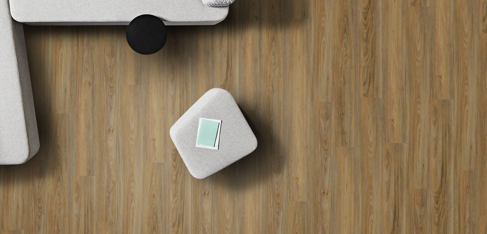 Small gray cube with a green label on a wooden surface